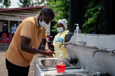 A man washes his hands before being screened to enter Kyeshero Hospital in Goma, Congo, on May 18, 2026.