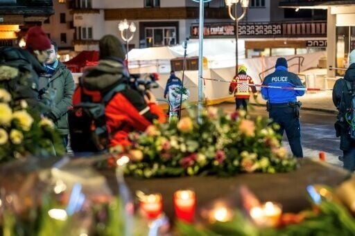 Flowers left at the scene of a fire that appears to have killed dozens in a Swiss ski resport