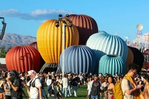 Coachella visitors walk near the "Starry Eyes" installation, designed by architect Kyriakos Chatziparaskevas