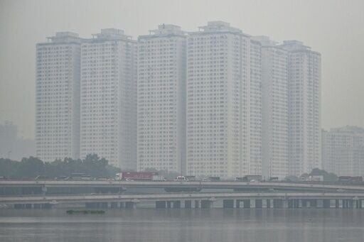 Vehicles drive on a highway during heavy air pollution in Hanoi on December 11, 2025
