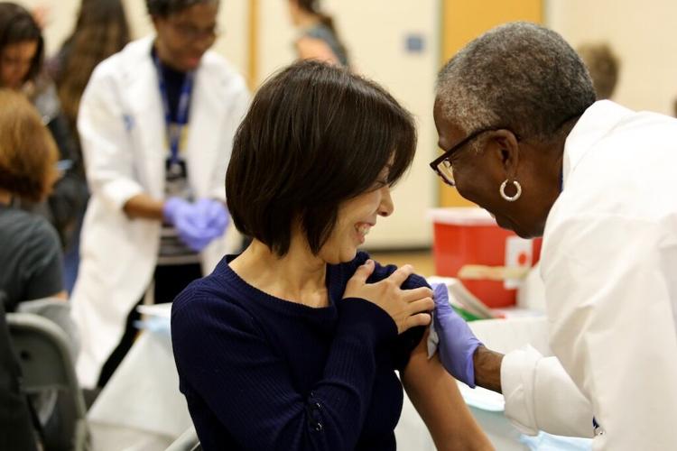 A woman receives a flu vaccination at a recent clinic in Cambridge, Mass.