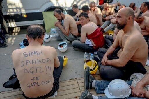 Several miners had slogans written across their bare skin