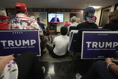 Phoenix residents watch presidential candidate Donald Trump speak at the Republican National Convention on July 18, 2024.
