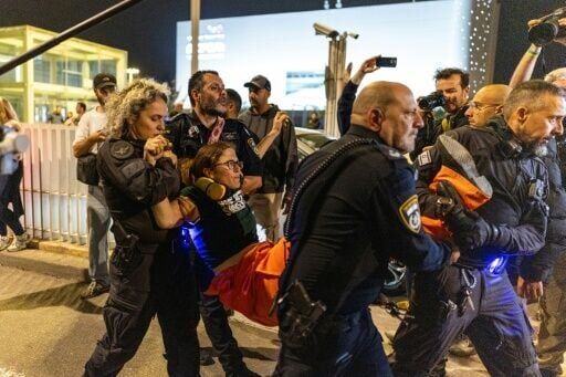 Israeli police arrest a demonstrator at HaBima Square in Tel Aviv who was protesting against the Iran war