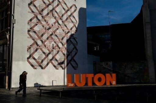 Pedestrians walk through the town centre in Luton, north of London, one of Britain's most diverse towns, with a non-white majority and an estimated 150 languages and dialects spoken on its streets and its places of worship