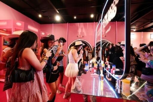 People test products inside the promotional booth of South Korean skincare brand Medicube