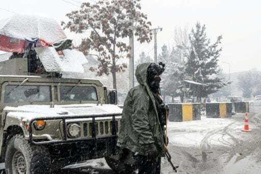 Taliban security personnel stand guard at a checkpoint in Kabul