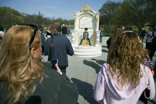 A long line of tourists formed to see the fake golden toilet installed near the White House