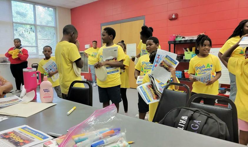 Handing out papers summer camp