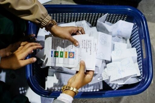 A box ticked for the Union Solidarity and Development Party is seen amongst advance vote ballots counted at a polling station in Mandalay on January 25