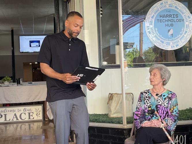 Marion Mayor reads proclamation to Jean Harris