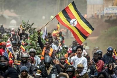 Bobi Wine supporters wave the flag at a rally this week