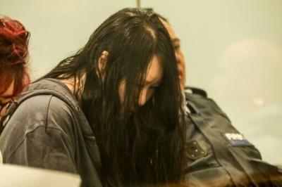 Flanked by security guards and a translator, 45-year-old Hakyung Lee showed little reaction as the sentence was handed down