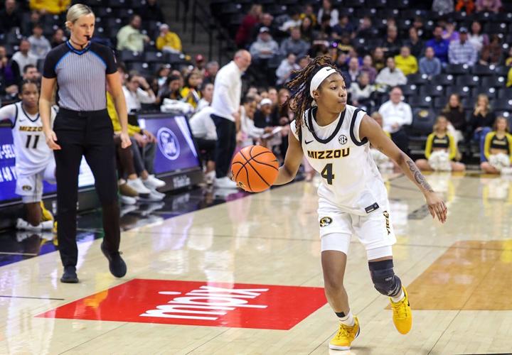 Mizzou guard Lisa Thompson (4) dribbles down the court