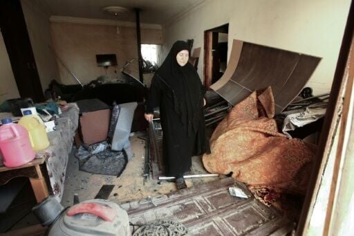 Outside her gutted home in southern Lebanon's Nabatieh, Zainab Farran keeps her clothes packed in a car in case the temporary truce between Hezbollah and Israel does not last