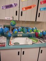 Kindergartners at Sophia P. Kingston use Selma Sun papers to make paper mache Earths