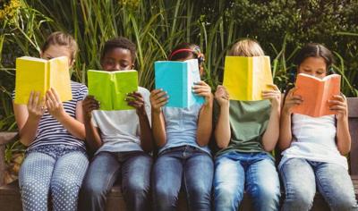Kids reading from ADN