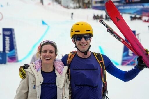Emily Harrop and Thibault Anselmet celebrate after winning gold for France in the ski mountaineering mixed relay