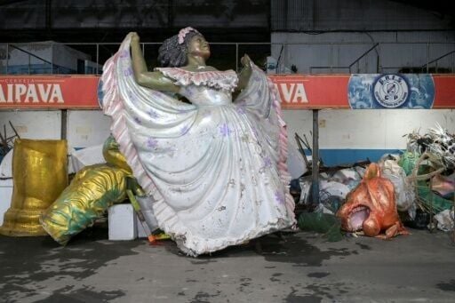 Remnants of donated props and floats from parades past are scattered around the space that lies under a viaduct and doubles as a parking lot for a driving school