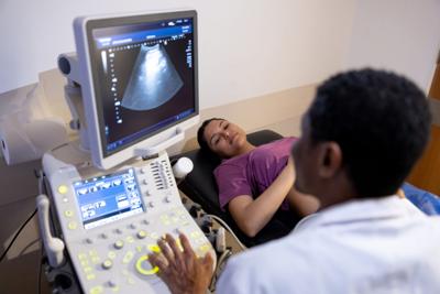 Obstetrician doing an ultrasound on a pregnant woman