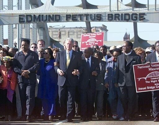 Jesse Jackson (2nd L), Coretta Scott King (3rd L), then US president Bill Clinton (4th L) and congressman John Lewis (5th L) walk over the Edmund Pettus Bridge in 2000 in Selma, Alabama to mark the 35th anniversary of the 1965 Voting Rights March