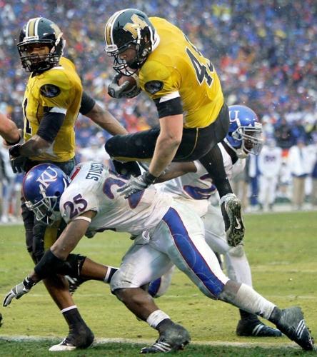 Missouri tight end Chase Coffman (45) leaps over Kansas safety Darrell Stuckey (25) to score a touchdown (copy)