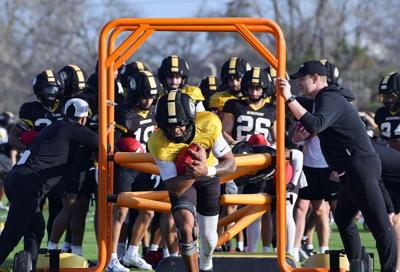 Quarterback Austin Simmons practices running drills (copy)