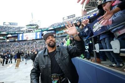 Seattle Seahawks defender Leonard Williams celebrates with fans during the NFL team's Super Bowl victory celebration and parade