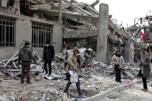 Iranians collecting belongings from a damaged residential building in Tehran on Thursday
