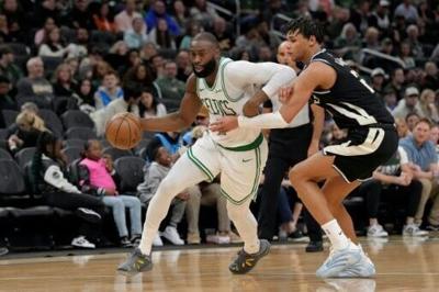 Boston Celtics star Jaylen Brown drives past Ousmane Dieng in the Celtics' NBA victory over the Milwaukee Bucks