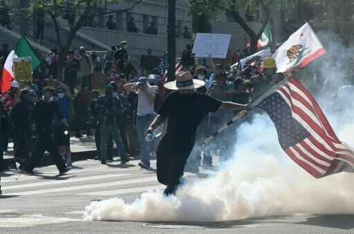 Trump flexes military might at parade as protests sweep US