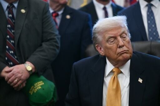 US President Donald Trump looks on before signing a bill on January 14, 2026 at the White House, where he discussed tensions with Iran