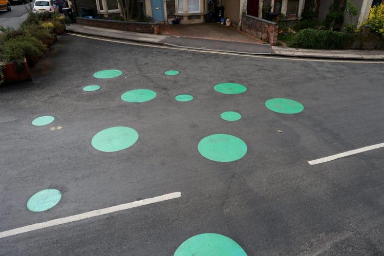 Mystery green spots on road leave residents baffled