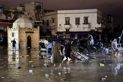 Residents wade through the town centre of Safi, on Morocco's coast, after a flash flood destroyed homes and businesses and killed at least 37