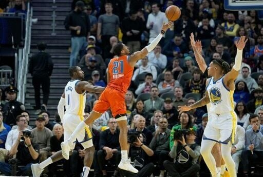 Oklahoma City's Aaron Wiggins shoots over the Golden State defense in the Thunder's 124-112 victory