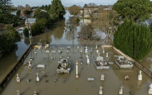 An aerial view shows floodwater surrounding a cemetery in Jusix in southwestern France