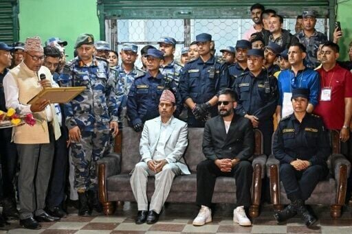 Rastriya Swatantra Party election candidate Balendra Shah (centre R) waits to collect a certificate for his victory in parliamentary elections at the counting centre in Damak in Nepal's Jhapa district