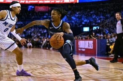 Memphis star Ja Morant drives past Anthony Black in the Grizzlies' NBA victory over the Orlando Magic in London