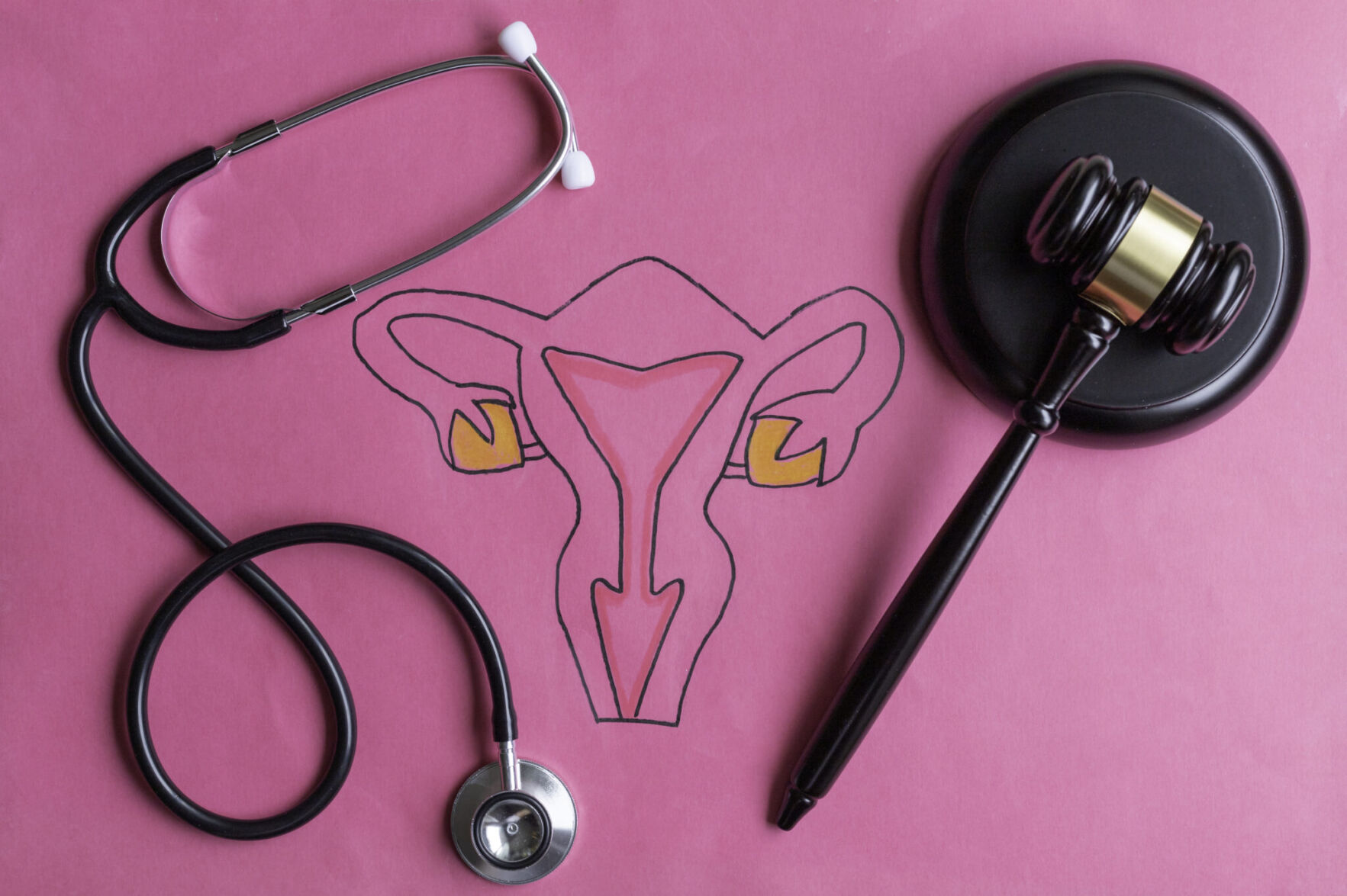 Drawing of female reproductive system with judge's gavel and stethoscope from Alabama Reflector