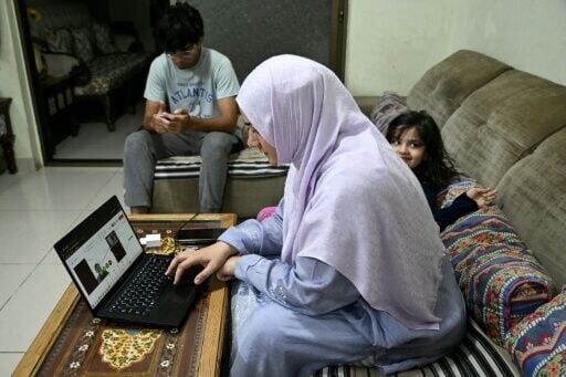 Doctor Saniya Jafri conducts an online consultation, alongside her daughter