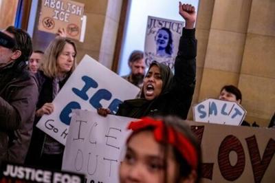 Protesters shout slogans against US Immigration and Customs Enforcement (ICE) at the office of Minnesota Governor Tim Walz at the Minnesota State Capitol Building in St Paul, on January 27, 2026