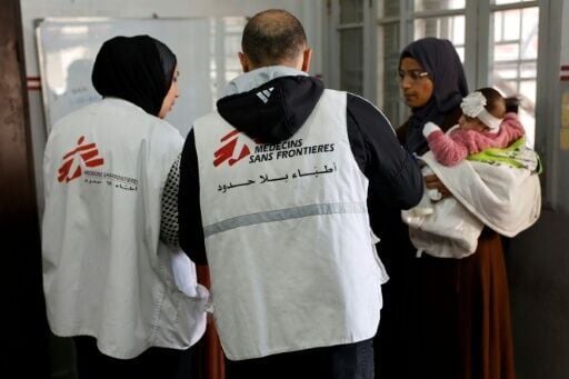 A Palestinian woman arrives with a child at a Doctors Without Borders clinic in Gaza City