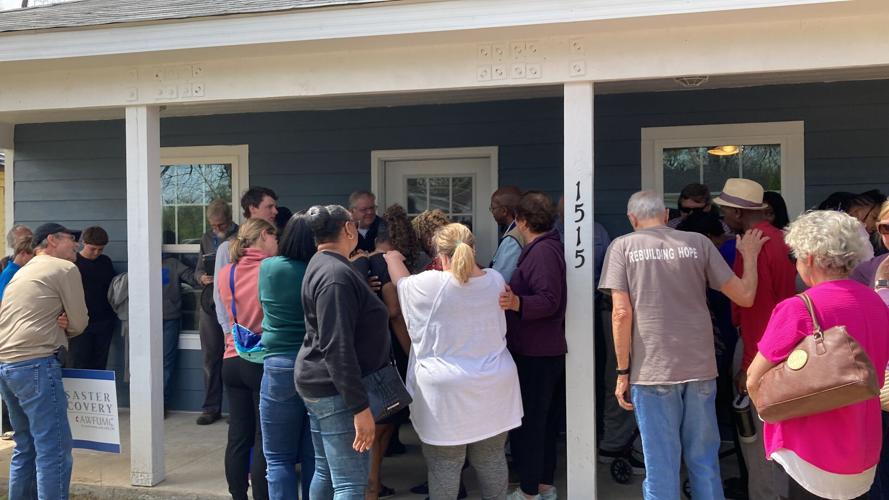 Praying over new homeowners with tornado homes