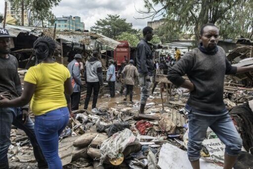 People survey the damage and try to salvage what they can after heavy flooding in the Kenyan capital