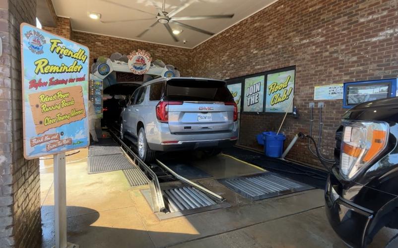 A steady stream of vehicles get personal attention at Big River Car Wash