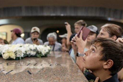 An attendee looks up at the light beam that shines through the roof of an Afrikaner memorial