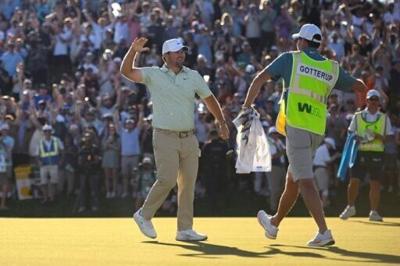American Chris Gotterup celebrates with his caddie after beating Hideki Matsuyama in a playoff to win the PGA Tour Phoenix Open