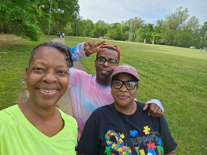 Joining Justin Rudoph for a walk in the park is Viveca Deans in the green was in town for her mother’s funeral. Behind her in the autism awareness shirt is Phyliss Houser who’s grandson is autistic.JPG