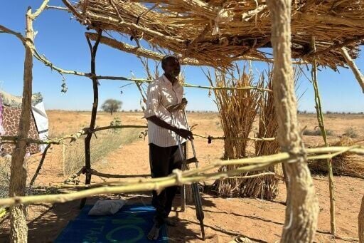 Ibrahim Noureldin leans on crutches at a makeshift shelter in the town of Tawila, Sudan