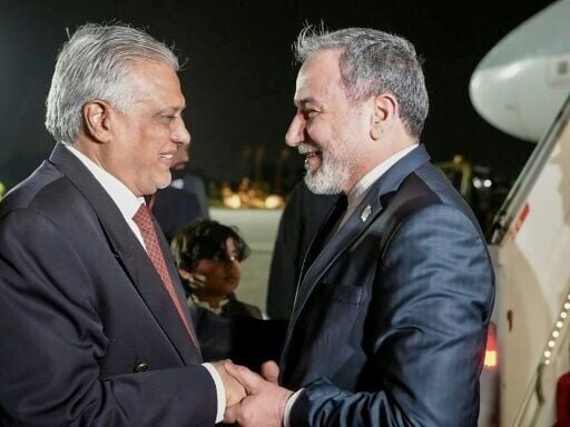 Pakistan’s Foreign Minister Ishaq Dar (L) greeting his Iranian counterpart Abbas Araghchi upon his arrival in Islamabad